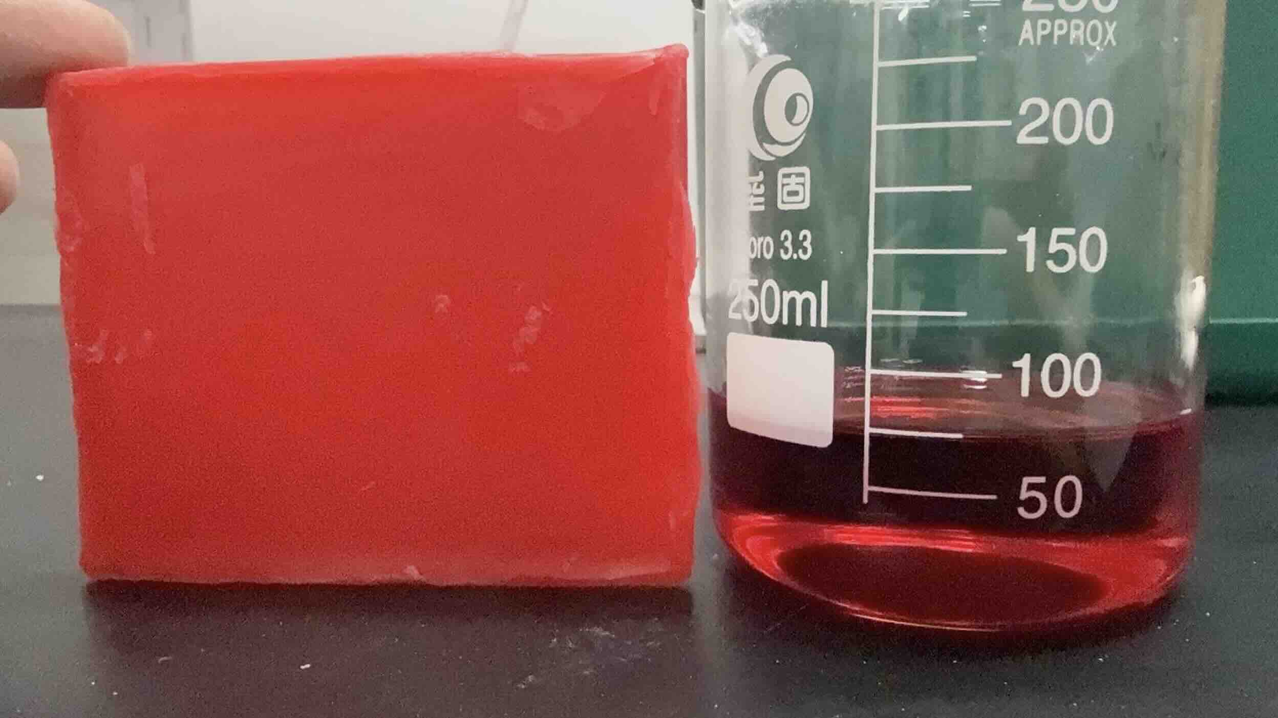 melted red wax and solid wax blocks